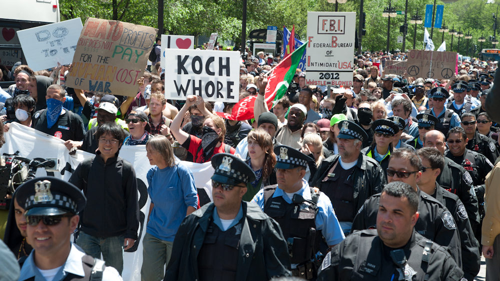 Police officers walk alongside peaceful protesters as they make their way to Boeing's headquarters in Chicago. (Photo by Norbert Schiller/Mint Press)