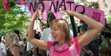 Medea Benjamin, a prominent activist with CodePink, holds a sign protesting NATO. CodePink was a leading force during the demonstrations in Chicago during the NATO summit. (Photo Norbert Schiller/Mint Press)