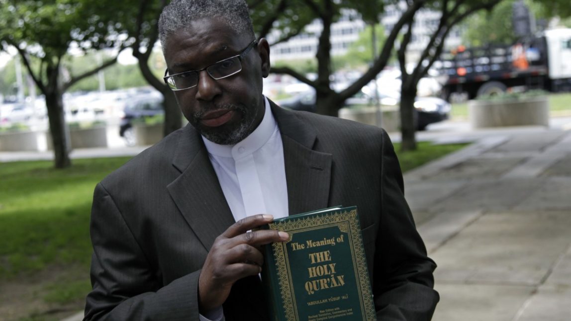 Imam Mustafa El-Amin holds a Quran that he plans to give to New Jersey Attorney General Jeffrey S. Chiesa at a meeting with religious leaders in Trenton, N.J., Thursday, May 24, 2012. Following a three-month review, Gov. Chris Christie's administration said Thursday that New York City police did not violate New Jersey laws when they conducted surveillance of Muslim businesses, mosques and student groups, rejecting demands by Muslim leaders for a formal investigation and a clampdown on cross-border police operations. (AP Photo/MelÂ Evans)