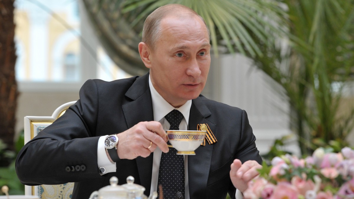 Russian President Vladimir Putin holds a cup of tea as he meets with Sonya, 8, not pictured, from the city of Pskov in Moscow's Kremlin on Wednesday, May 9, 2012. Sonya undergoes a medical treatment at Federal Scientific Center for Child's Oncology in Moscow. (AP Photo/RIA Novosti, Alexei Druzhinin, Government Press Service)