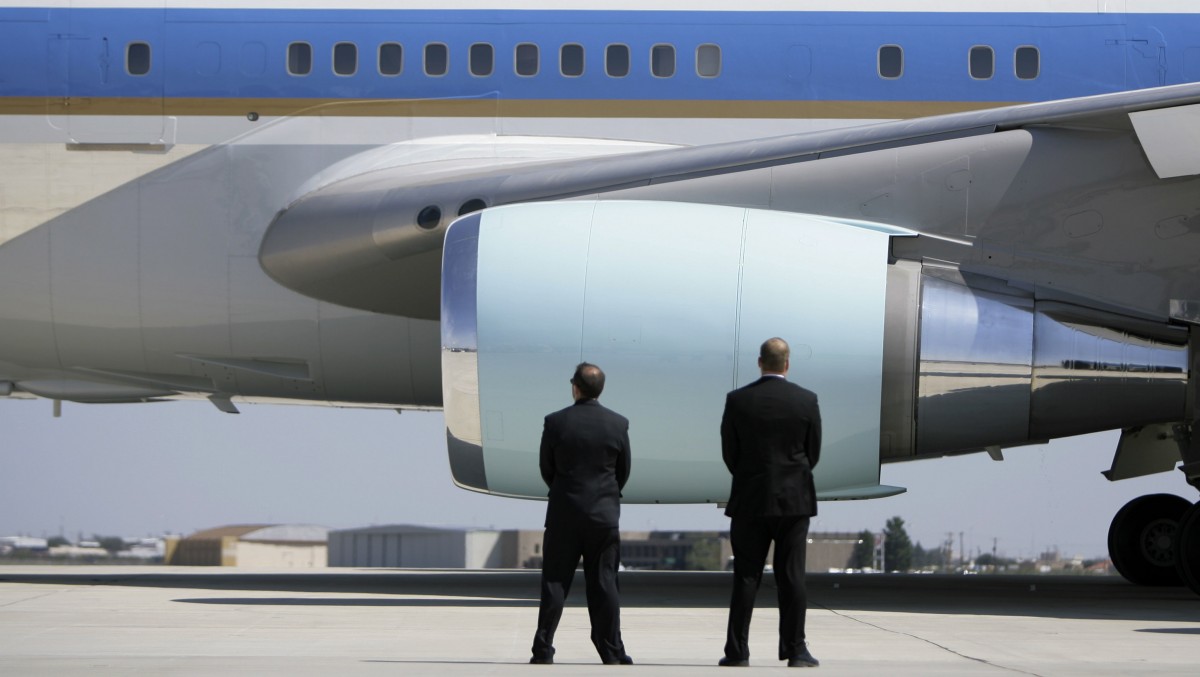 In this Saturday, Oct. 4, 2008 photo, Secret Service agents watch as Air Force One departs Midland International Airport with President Bush and first lady Laura Bush aboard in Midland, Texas. The Secret Service has been tarnished by a prostitution scandal that erupted April 13, 2012 in Colombia involving 12 Secret Service agents, officers and supervisors and 12 more enlisted military personnel ahead of President Barack Obama's visit there for the Summit of the Americas. (AP Photo/Matt Slocum)