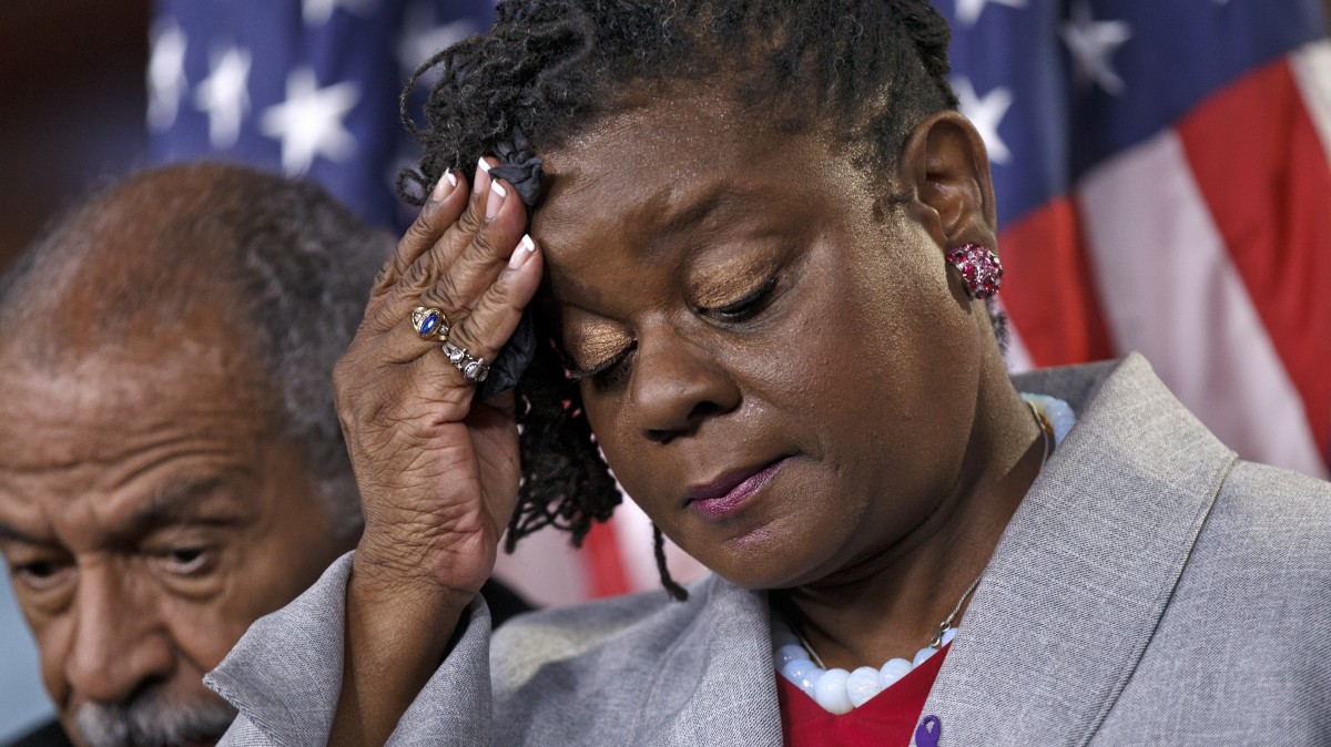 Rep. Gwen Moore, D-Wis., accompanied by Rep. John Conyers, D-Mich, pauses during a news conference on Capitol Hill in Washington, Wednesday, May 16, 2012, to push for the unrestricted reauthorization of the Violence Against Women Act. (AP Photo/J. Scott Applewhite)