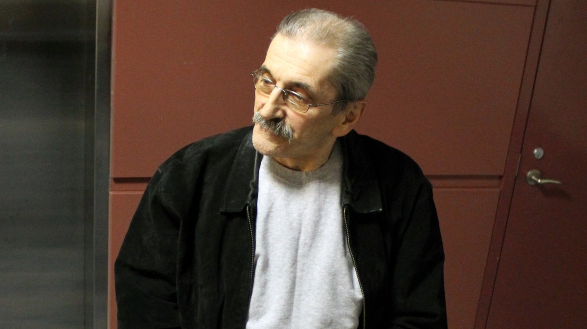 In this photo provided by U.S. Immigration and Customs Enforcement, former Bosnian-Serb police commander tied to Srebrenica genocide Dejan Radojkovic, 61, arrives at McCarran Airport in Las Vegas, for the initial leg of his removal flight back to Sarajevo. The former Bosnian Serb police commander accused of playing a leading role in the 1995 massacre of Bosnian Muslims in Srebrenica has been deported to his native country, U.S. officials said Thursday May 24, 2012. (AP Photo/U.S. Immigration and Customs Enforcement)