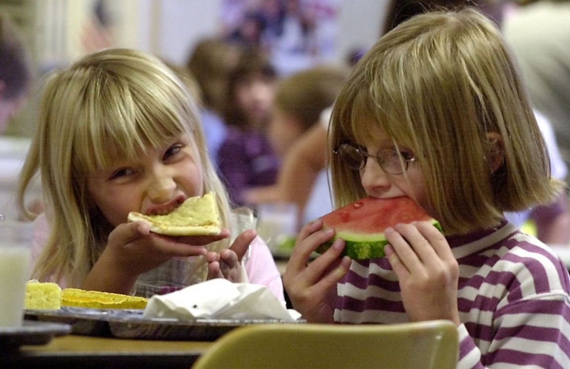 FILE-In this Sept. 24, 2002 , file photo, Kayla Reynolds, 6, left, and Kirsten Desorda, 7, enjoy eating lunch at the Thatcher Brook Elementary School in Waterbury, Vt. The percentage of Vermont students receiving free or reduced priced lunches is increasing. (AP Photo/Toby Talbot)