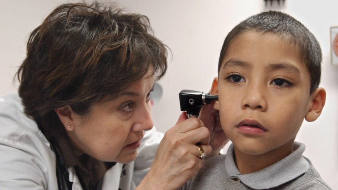 Doctor Chris Taylor, left, examines the ear of Medi-Cal patient Richardo Alvarez, 5, at the Las Palmas Health Clinic in Sacramento, Calif., Thursday, March 3, 2005. (AP Photo/Rich Pedroncelli)
