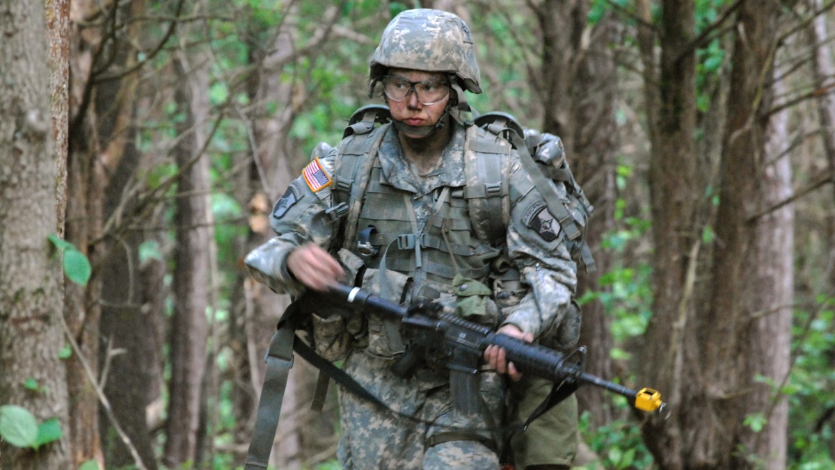 In a May 9, 2012 photo, Capt. Sara Rodriguez of the 101st Airborne Division walks through the woods during the expert field medical badge testing at Fort Campbell, Ky., on May 9, 2012. (AP Photo/Kristin M. Hall)
