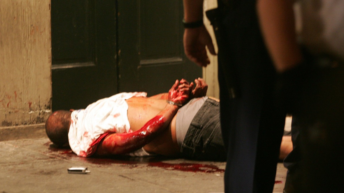 A bloodied man lies handcuffed on the sidewalk after being arrested by police on Conti Street near Bourbon Street in the French Quarter of New Orleans Saturday night, Oct. 8, 2005. At least one police officer repeatedly punched the 64-year-old Robert Davis, accused of public intoxication, and another officer assaulted an Associated Press Television News producer as a cameraman taped the confrontations. (AP Photo/Mel Evans)