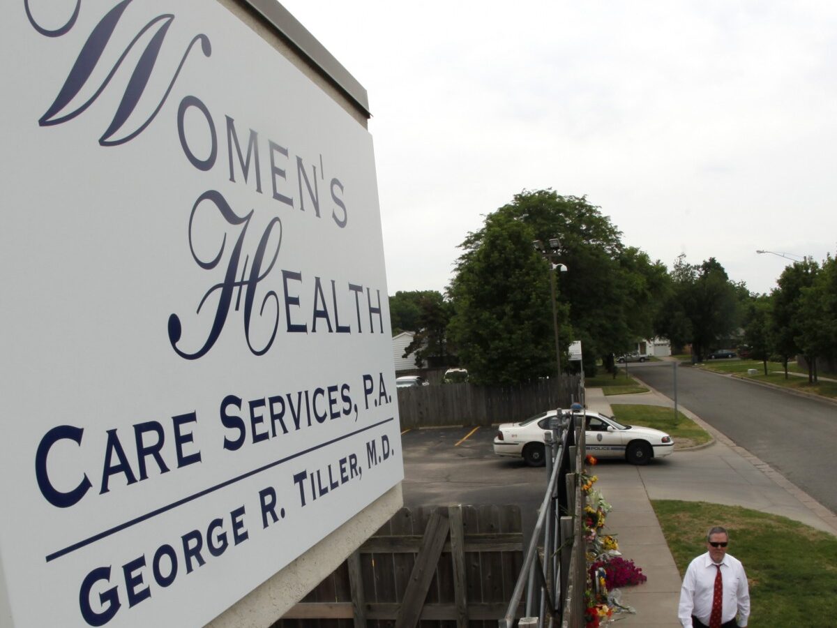 In this Tuesday, June 2, 2009 file photo, John Pride, of Wichita, Kan., walks past a memorial outside Women's Health Care Services in Wichita, Kan. Thursday, the Senate passed the Homeland Security Bill 2012 which includes a stipulation to ban illegal immigrants abortions while in custody. (AP Photo/Charlie Riedel, file)