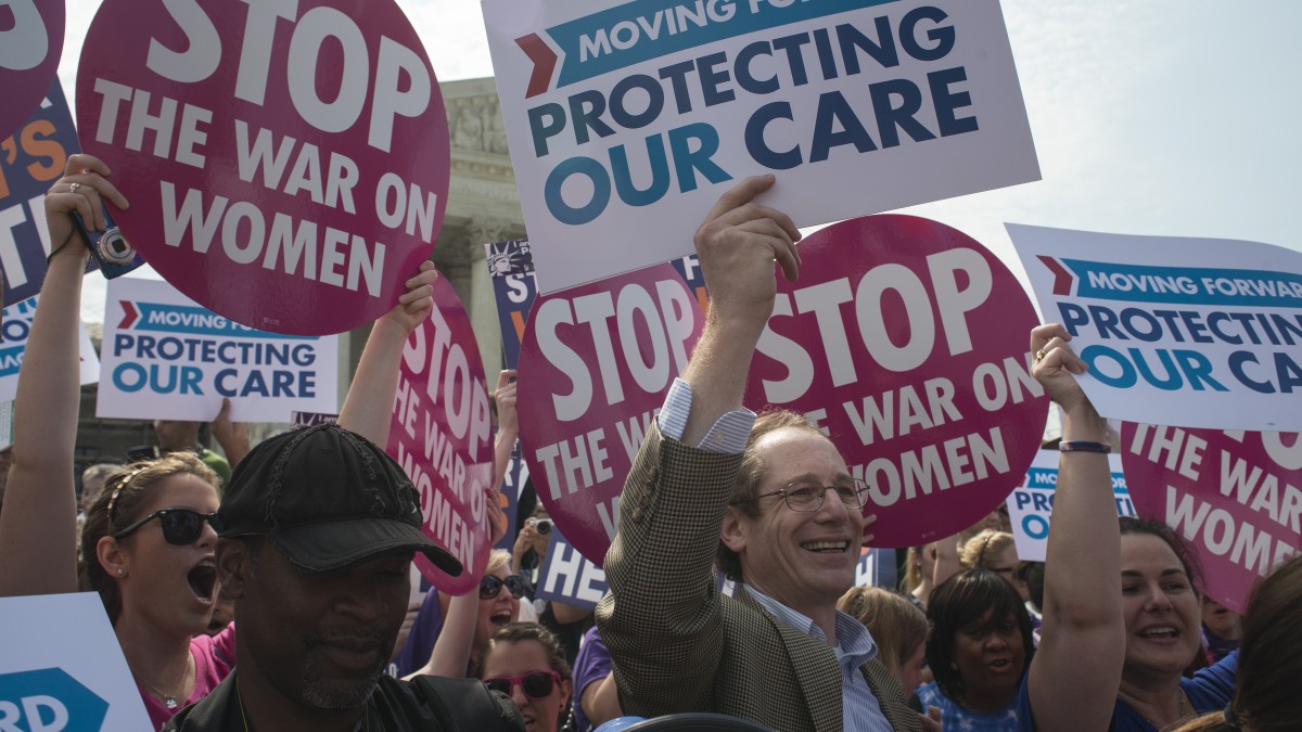 Kurt Edelman from New York smiles at the announcement that the U.S. Supreme Court upheld the Obama administration's health care law in a landmark 5-4 decision in Washington, DC, June 28, 2012. (Mannie Garcia / MintPress News 2012)