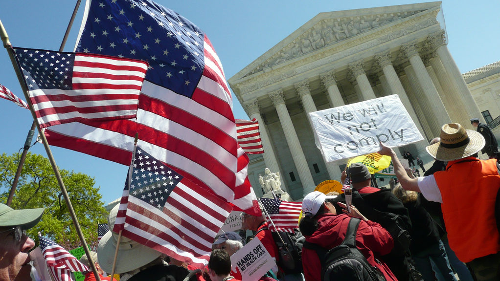 Protesters stand outside the Supreme Court during the second day of the Affordable Care Act arguments March 27,2012 (Photo by Angela N. via Flikr)