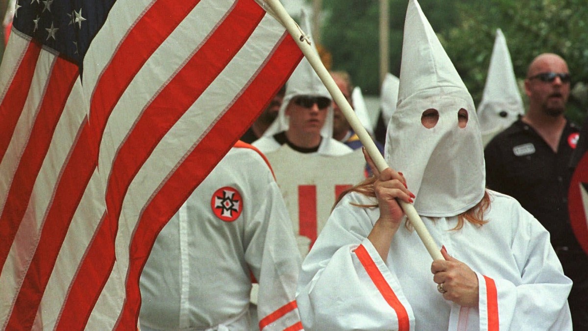 Members of the Church of the American Knights of the Ku Klux Klan march around the Madison County Courthouse in Canton, Miss. (AP Photo/Rogelio Solis)