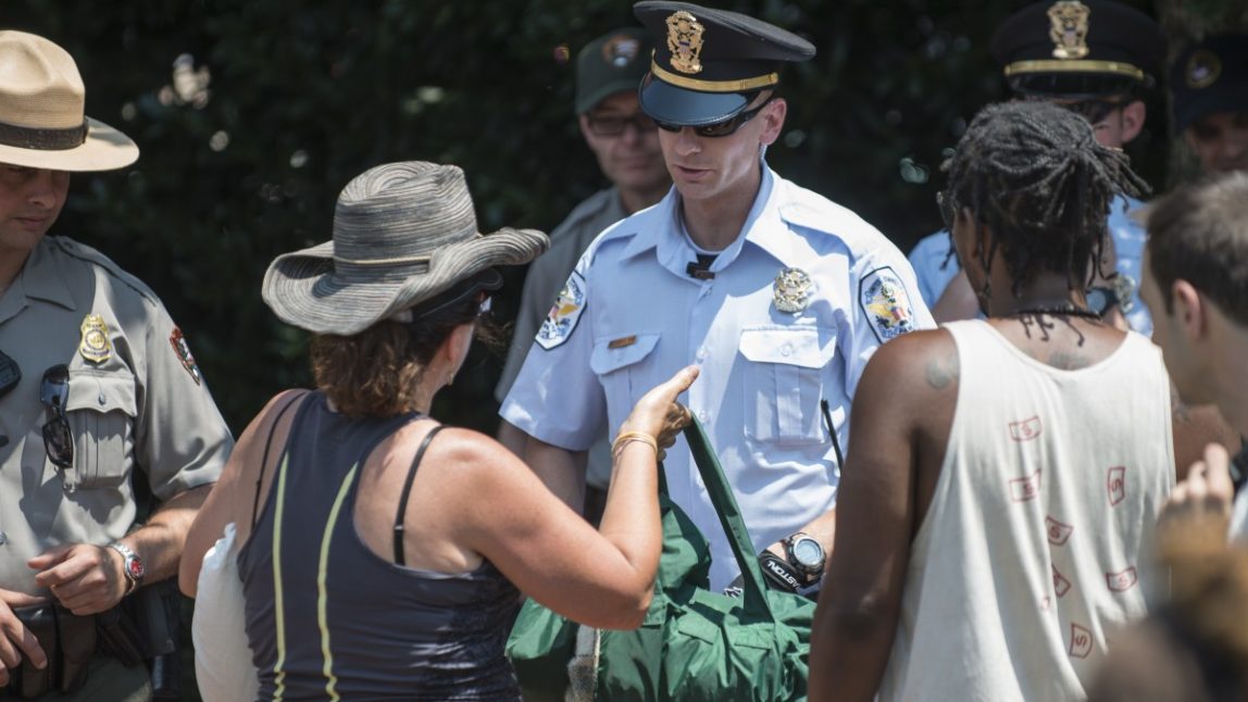An Occupy protester confronts a police officer in Philadelphia June 30, 2012. (Mannie Garcia/MintPress)