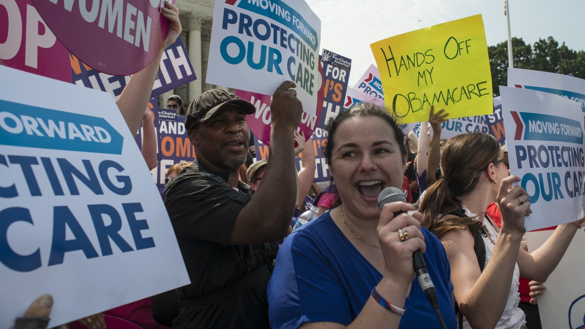 Deborah Tannenbaum from Washington, DC cheers into a microphone at the announcement that the US Supreme Court upheld the Obama administration's health care law in a landmark 5-4 decision in Washington, DC, June 28, 2012. (Mannie Garcia / MintPress News 2012)