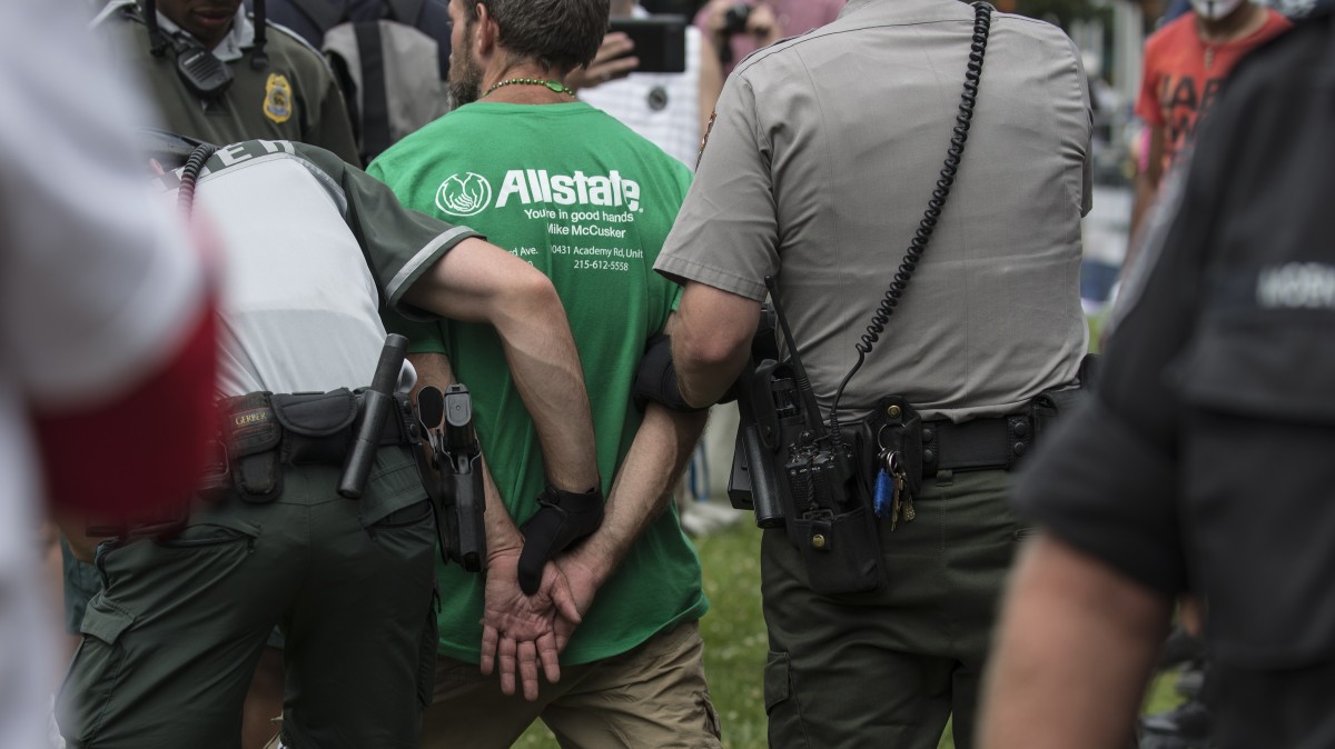 An Occupy protester is detained by police Saturday, June 30, 2012 during the Occupy National Gathering. The activist was searched and later released. (Mannie Garcia/MintPress)