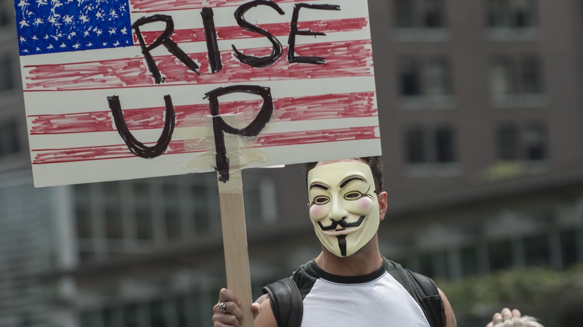 An Occupy protester encourages others to 'Rise Up' in Philadelphia June 30, 2012. (Mannie Garcia/MintPress)
