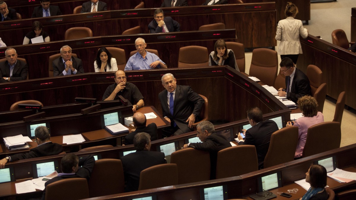Israeli Prime Minister Benjamin Netanyahu, center, attends a session at the Knesset, Israel's parliament. (AP Photo/Sebastian Scheiner)