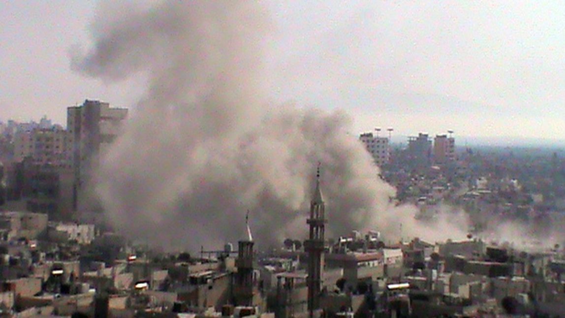 This citizen journalism image provided by Shaam News Network SNN and taken on Thursday, June 21, 2012, purports to show smoke from shelling rising up from buildings in the Khaldiyeh neighborhood of Homs province, central Syria. (AP Photo/Shaam News Network, SNN)