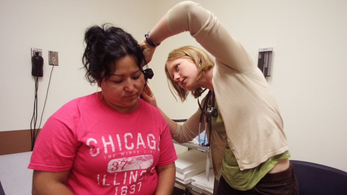 In this June 25, 2012, photo, physician assistant Anna Streuli, right, examines Maria Guzman at the Multnomah County's Mid-county Health Center, in Portland, Ore. (AP Photo/Rick Bowmer)