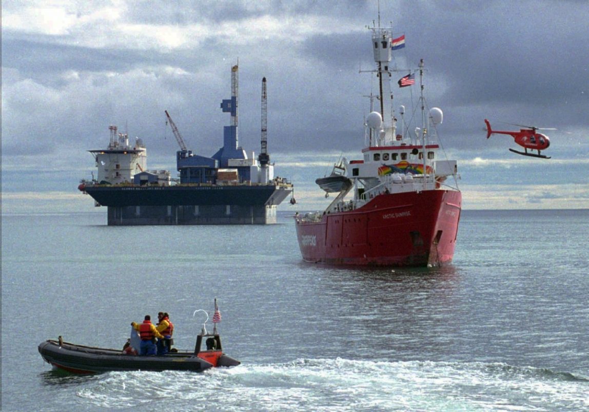 A 160-foot Greenpeace ship, the Arctic Sunrise and the environmental group's helicopter tries to block the movement an offshore drilling rig. (AP Photo/U.S. Coast Guard)