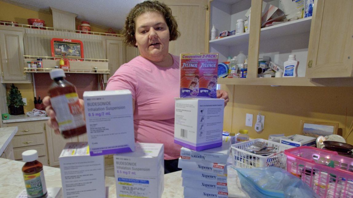 In this Saturday, March 3, 2012 photo, Nicole Maurer stacks boxes of medicine and medical devices on her kitchen counter in Boothville, La. Maurer believes the illnesses of she and her family are related to the Gulf oil spill. (AP Photo/Matthew Hinton)