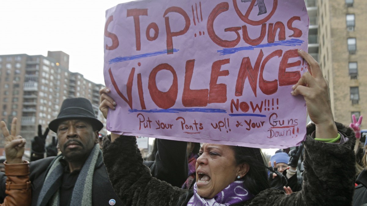 Martina Garcia, right, of the Hispanic Community Organization For Life, speaks about witnessing too much violence in her community during a Harlem march and vigil against gun violence. (AP Photo/Kathy Willens)