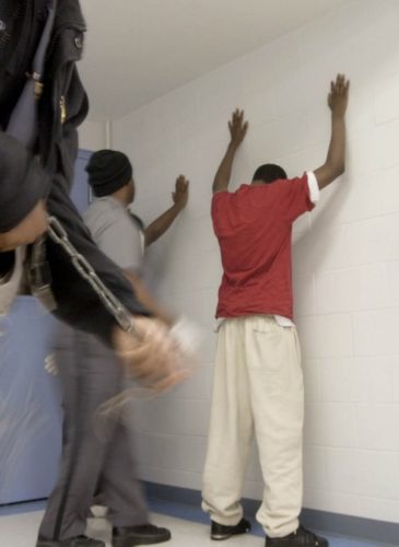New prisoners at the Department of Youth Services Detention Center begin the intake process by being searched Thursday, Jan. 31, 2002. (AP Photo/Will Shilling)
