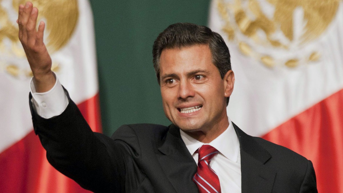 Presidential candidate Enrique Pena Nieto waves to supporters at his party's headquarters in Mexico City, early Monday, July 2, 2012. Mexico's old guard sailed back into power after a 12-year hiatus Sunday as the official preliminary vote count handed a victory to Enrique Pena Nieto, whose party was long accused of ruling the country through corruption and patronage. (AP Photo/Christian Palma)