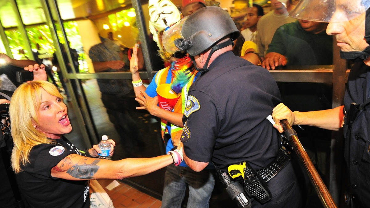 Demonstrators gather on the steps of Anaheim City Hall Tuesday afternoon July 25, 2012, to protest the death of Manuel Diaz, 25, who died as a result of gunshot wounds sustained during a police pursuit by the Anaheim Police Department last Saturday on North Anna Drive. (AP Photo/The Orange County Register,Stuart Palley )