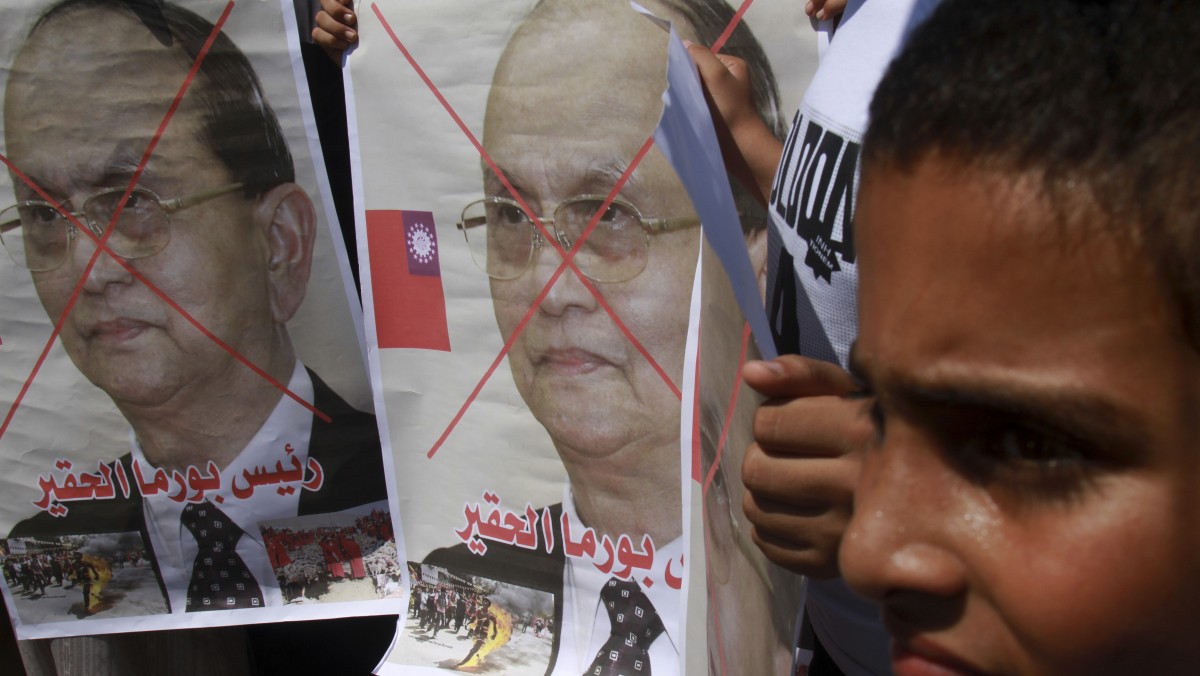 Palestinians hold posters of Myanmar's President Thein Sein reading in Arabic "President of Burma, despicable," during a demonstration calling to stop killing the Burmese Muslims in Myanmar, in front of the United Nations Special Coordinator for the Middle East Peace Process (UNSCO) offices in Gaza City, Wednesday, July 18, 2012. Dozens of Muslims were killed and thousands were displaced in communal clashes in Myanmar in recent months. (AP Photo/Adel Hana)