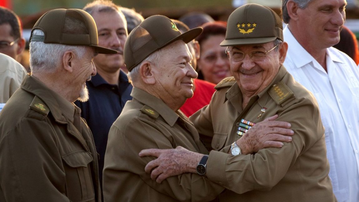 Cuba's President Raul Castro, right, embraces Commanders of the Revolution Guillermo Garcia Frias, center, and Ramiro Valdez, left, at an event celebrating Revolution Day in Guantanamo, Cuba, Thursday, July 26, 2012. (AP Photo/Ramon Espinosa)
