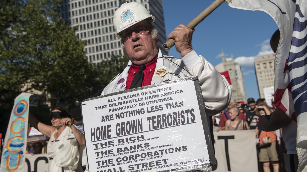 An Occupy activist marches through the streets of Philadelphia, PA July, 2, 2012 as the Occupy National Gathering takes place. (Mannie Garcia/MintPress)