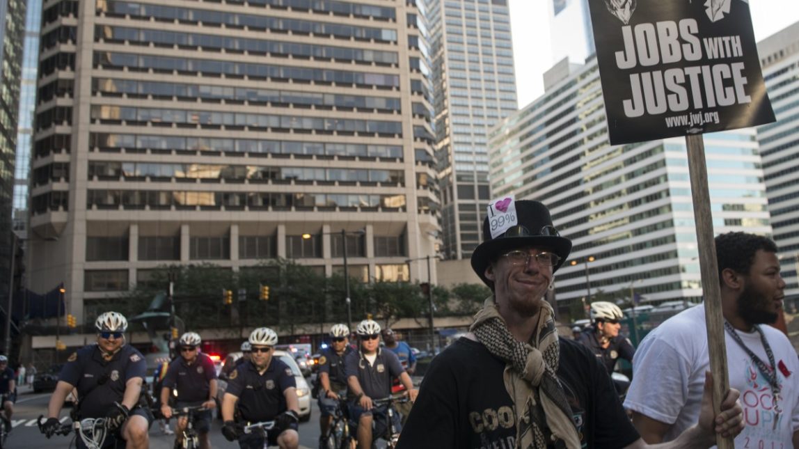 Police officers follow protesters on bicycles during a march in Philadelphia July 2, 2012. (Mannie Garcia/MintPress)