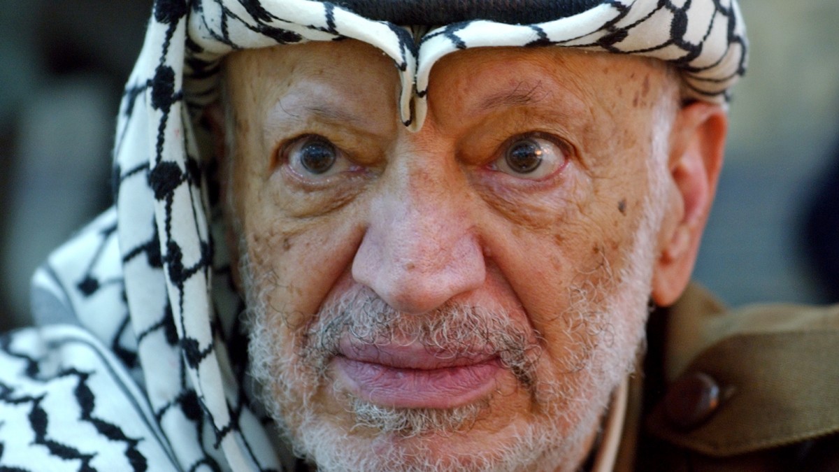 In this Saturday, Oct. 2, 2004 file photo, Palestinian leader Yasser Arafat pauses during an emergency cabinet session, at his compound, in the West Bank town of Ramallah. (AP Photo/Muhammed Muheisen, File)