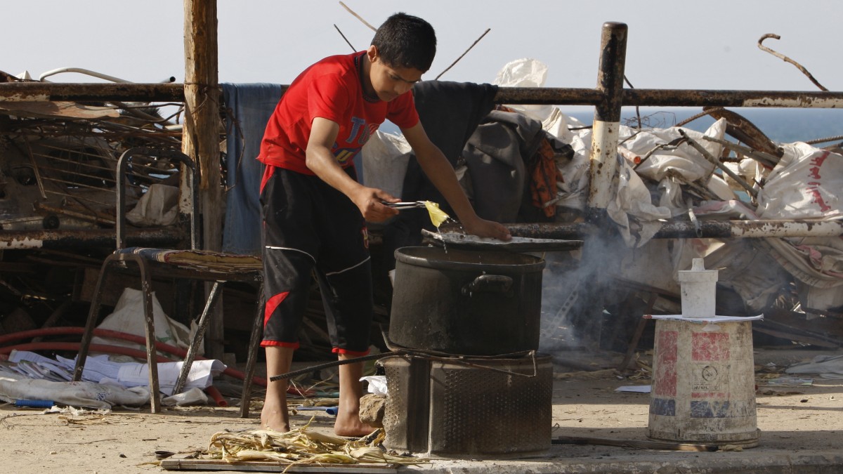 A Palestinian street vendor sells corn near the beach of Gaza City, Thursday, June 14, 2012. (AP Photo/Adel Hana)