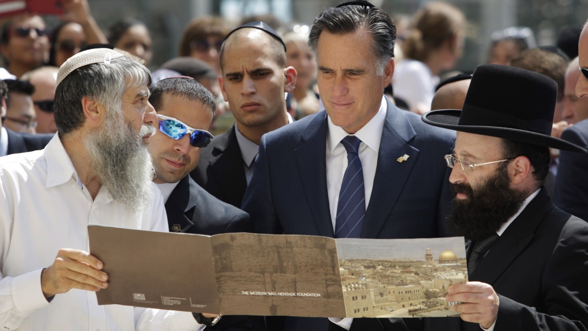Republican presidential candidate and former Massachusetts Gov. Mitt Romney is presented with a booklet as he visits the Western Wall, in Jerusalem, Sunday, July 29, 2012. (AP Photo/Dan Balilty)