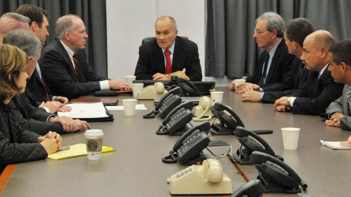 In a Sept. 26, 2009, file photo released by the New York City Police Department, Police Commissioner Raymond Kelly, center, briefs New York police officials and John O. Brennan, center left, assistant to the president for Homeland Security and Counter-terrorism, and Deputy New York Police Commissioner of Intelligence David Cohen, center right, on events surrounding the alleged plot to bomb New York commuter trains, at Police Headquarters in New York. (AP Photo/NYPD, File)
