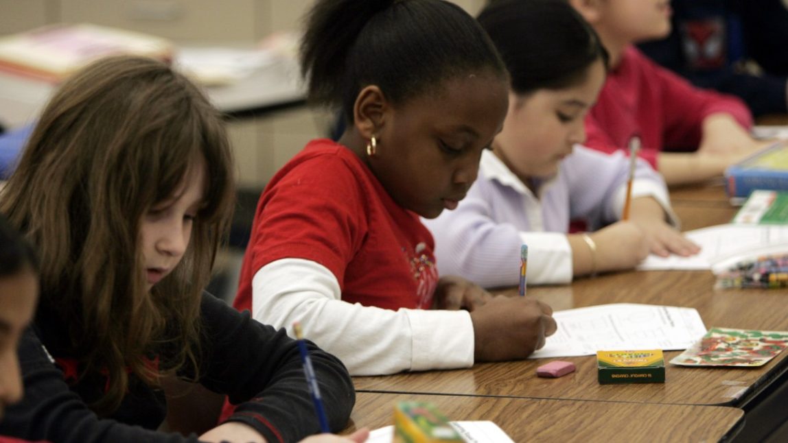 Third graders Danielle Levin, 8; Paige Simpson, 8; and Daniella Gama-Diaz, 8; from left, work on a lesson at Eagle Elementary School in West Bloomfield Township, Mich., Thursday, March 9, 2006. Under the federal No Child Left Behind Act, all students must achieve proficiency in reading and math by 2014, but more and more states are opting out of the legislation. (AP Photo/Carlos Osorio)