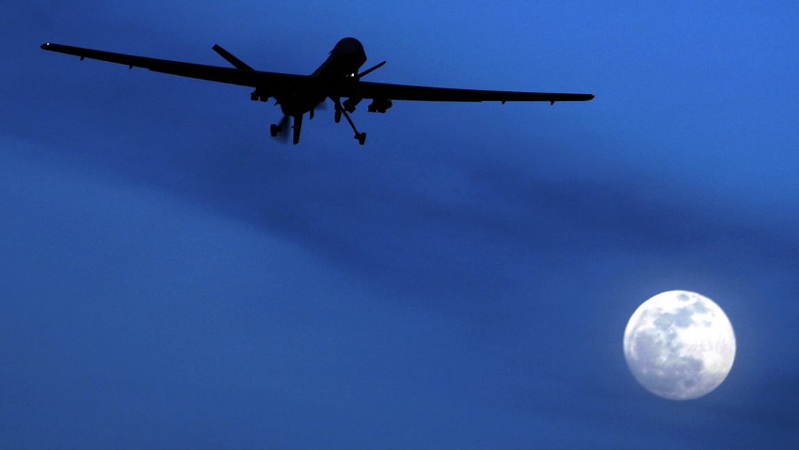 In this Jan. 31, 2010 file photo, an unmanned U.S. Predator drone flies over Kandahar Air Field, southern Afghanistan, on a moon-lit night. (AP Photo/Kirsty Wigglesworth, File)
