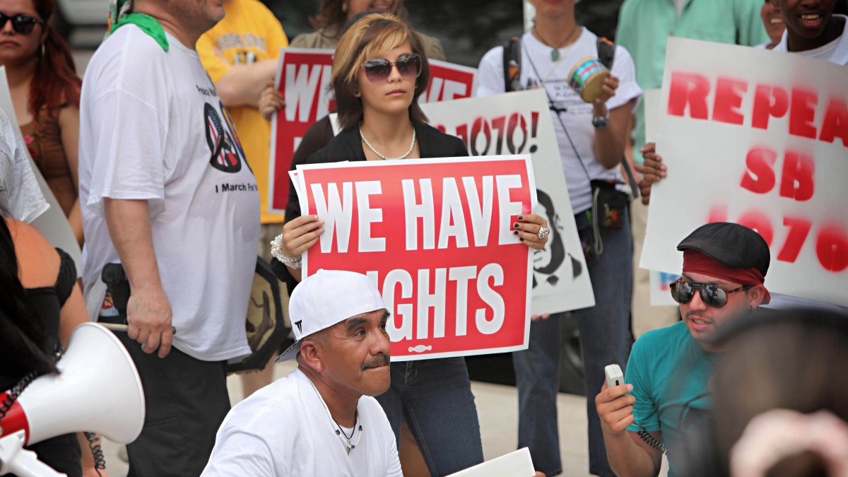 Opponents of Arizona's immigration law SB1070 gather outside the Sandra Day O'Connor Federel Courthouse in Phoenix. (AP Photo/Matt York)