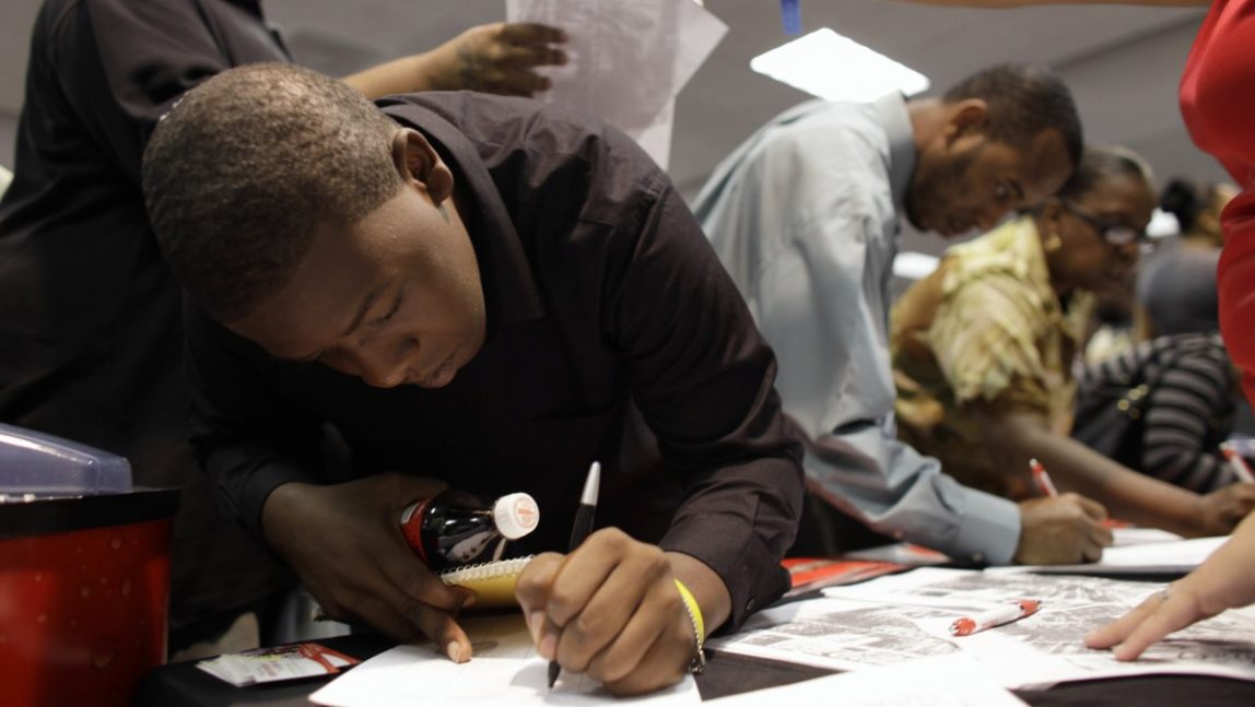 Dedric Stafford, 18, of Miami, fills out a form with Coca-Cola at a jobs fair hosted by the Congressional Black Caucus in Miami, Tuesday, Aug. 23, 2011. The fair is aimed at lowering the especially high rate of unemployment in the black community. (AP Photo/Lynne Sladky)