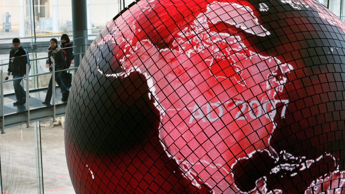 Visitors walk past images of a climate color coded globe of the world projected on the Geo-Cosmos, a sphere with a diameter of 6.5 meters (21 feet), Saturday, Feb. 3, 2007, at Tokyo's MeSci, or The National Museum of Emerging Science and Innovation. The dark red/black areas represent no current changes in climate. The lighter red/pink areas represent some sort of change in climate and the white areas symbolize a very high level of change. (AP Photo/Koji Sasahara)