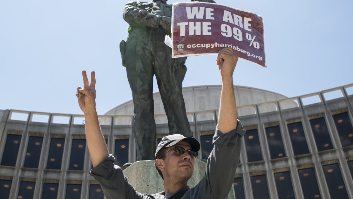 An Occupy protester stands at the Round House in Philadelphia, joining other Occupy members at the Occupy National Gathering. (Mannie Garcia/MintPress)