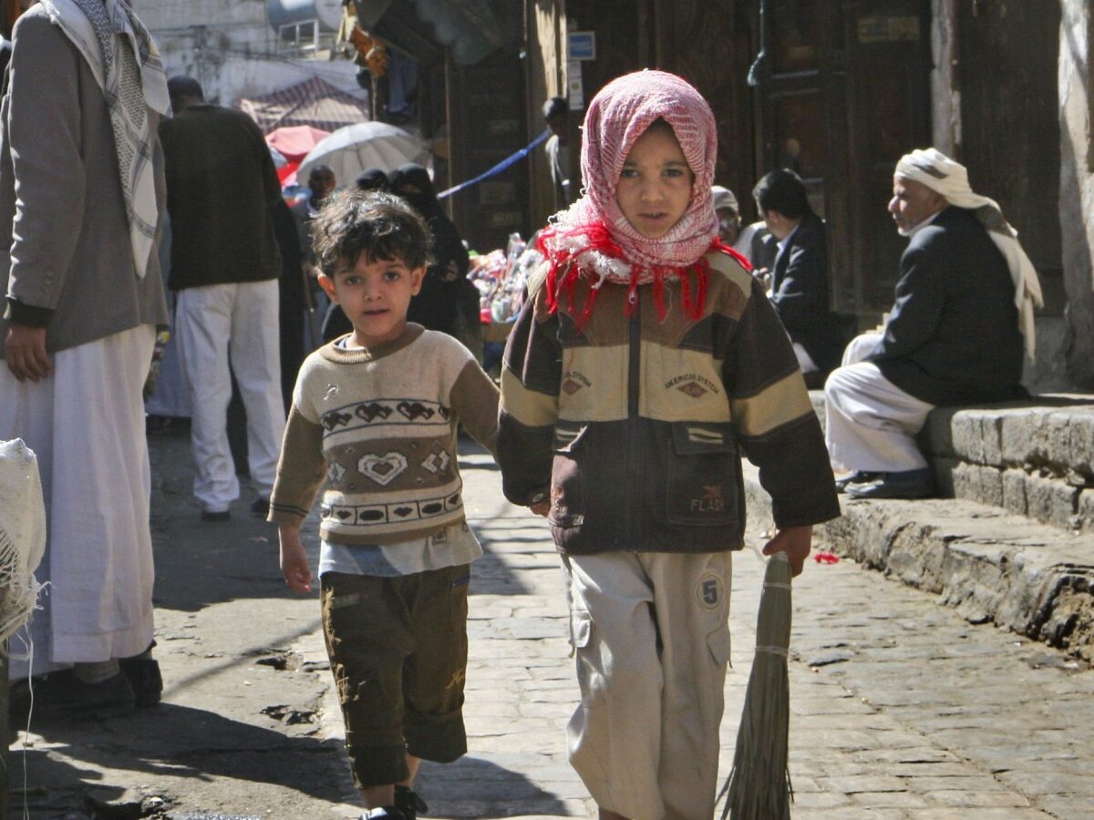 Two children walk along a market street in the capital San'a, Yemen, Dec. 3, 2008. Even in Yemen's breadbasket, people are having trouble feeding themselves in what food experts say is a hidden but growing hunger problem across this impoverished country, the poorest in the Middle East, that could push it to collapse. (AP Photo/Paul Schemm)