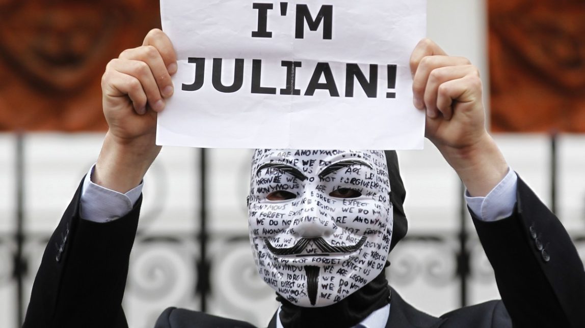 A supporter of WikiLeaks founder Julian Assange holds up a placard outside the Ecuadorian Embassy in central London, London, Thursday, Aug. 16, 2012. (AP Photo/Sang Tan)