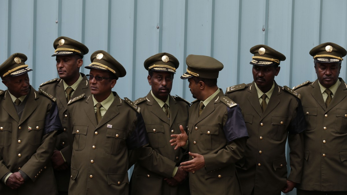 Military officers wait to pay their respects to the coffin of Prime Minister Meles Zenawi, at the national palace, the official residence of the prime minister, in Addis Ababa, Ethiopia Friday, Aug. 24, 2012. (AP Photo/Rebecca Blackwell)