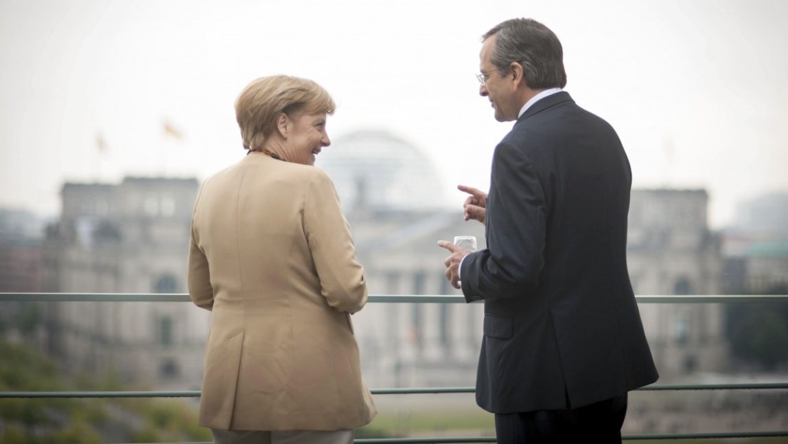In this picture provided by the German Government German Chancellor Angela Merkel talks with Prime Minister of Greece Antonis Samaras, right, on the terrace of the federal chancellery in Berlin, Germany, Friday, Aug. 24, 2012. Building in the background is the German parliament Reichstag. (AP Photo/Bundesregierung/Guido Bergmann)