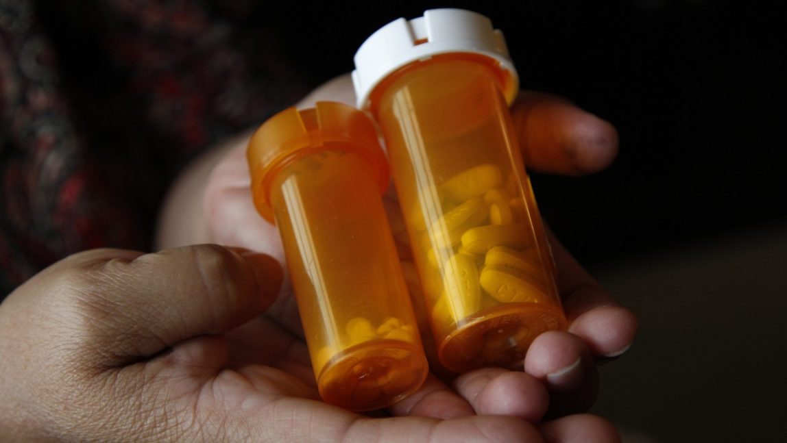 A woman holds medications she takes for various medical conditions Thursday, July 26, 2012. (AP Photo/Lynne Sladky)