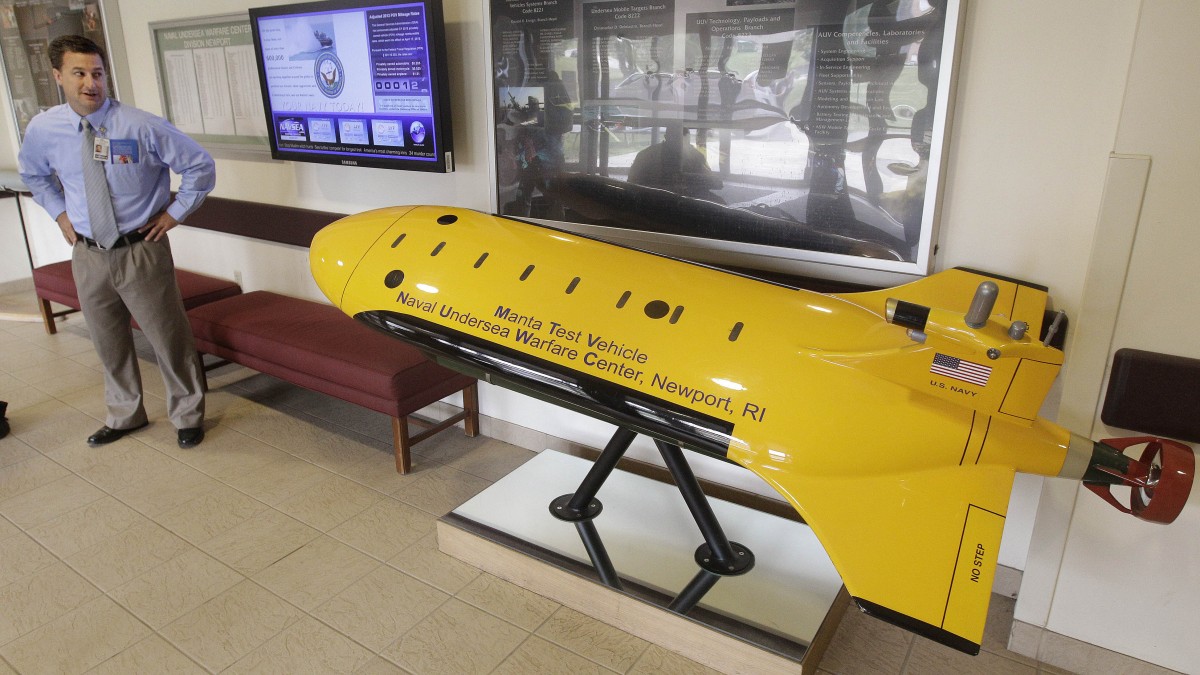 Christopher Del Mastro, head of anti submarine warfare mobil targets at the Naval Undersea War Center, stands next to a mock up of their Manta Test Vehicle in Middletown, RI., Tuesday, July 31, 2012. (AP Photo/Stephan Savoia)