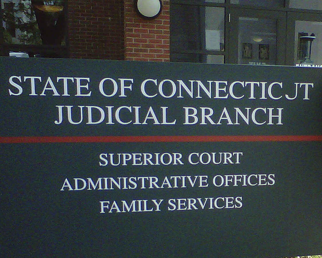In this Wednesday, Aug. 8, 2012 photo, Jennifer Garcia, 23, of Hartford, Conn., stands in front of Hartford Family Court after a child visitation hearing. Garcia is among scores of people nationwide who have been representing themselves in court because they can't afford a lawyer. Court officials across the country and the American Bar Association have been pushing to get more attorneys to provide free legal services to those in need. (AP Photo/Dave Collins)