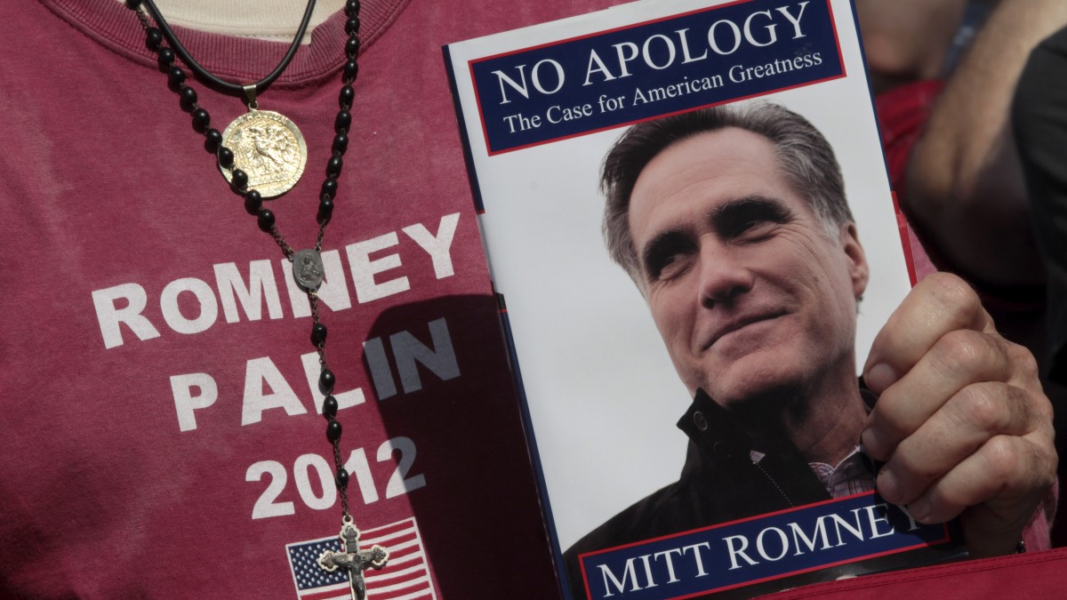 A supporter of Republican presidential candidate, former Massachusetts Gov. Mitt Romney holds his book during a campaign event at Flagler college, Monday, Aug. 13, 2012, in St. Augustine, Fla. (AP Photo/Mary Altaffer)